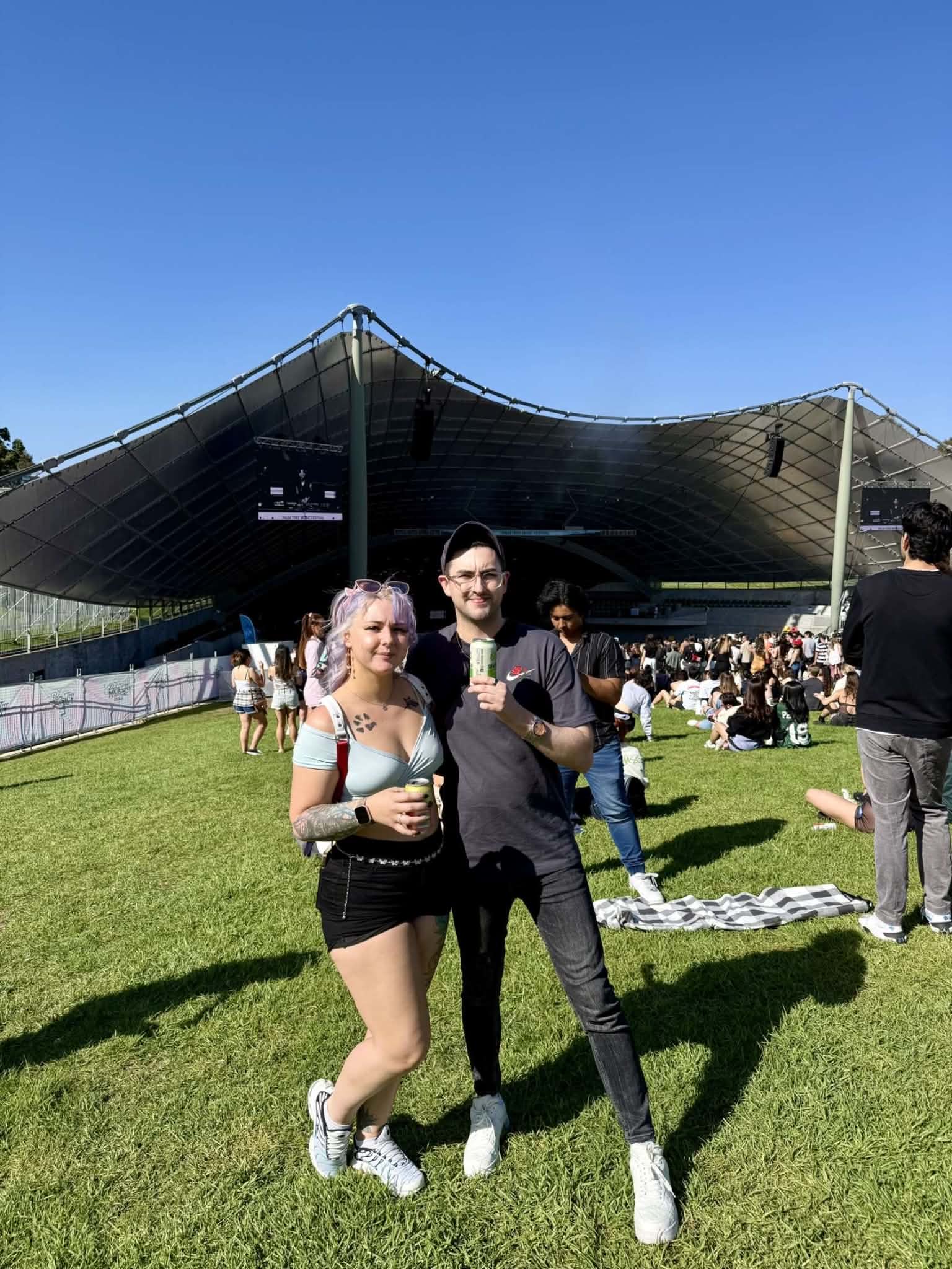 The two of them standing together on a sunny lawn under a blue sky