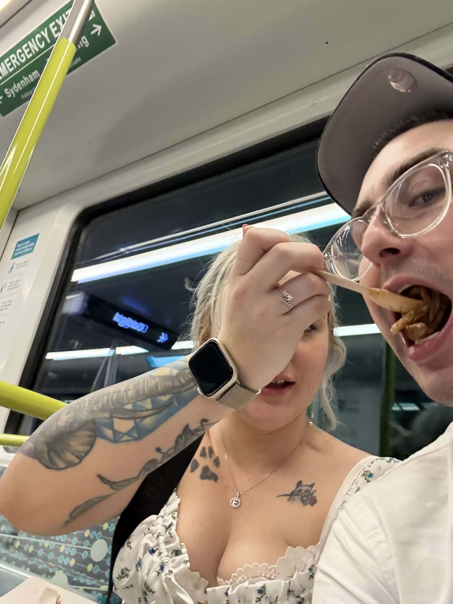A candid shot sharing food on a train